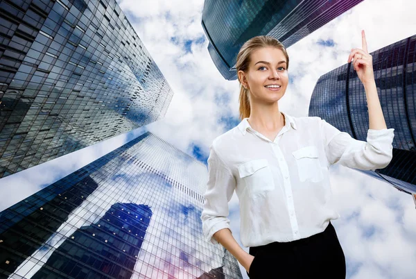 Young business woman raises forefinger up over background. — Stock Photo, Image