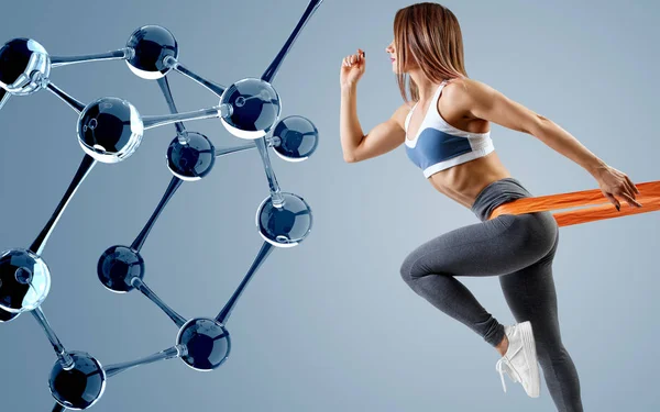 Athletic woman standing near glass molecule chain. — Stock Photo, Image