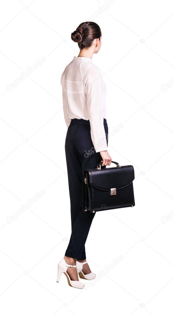 Elegant woman in business suit walking away.