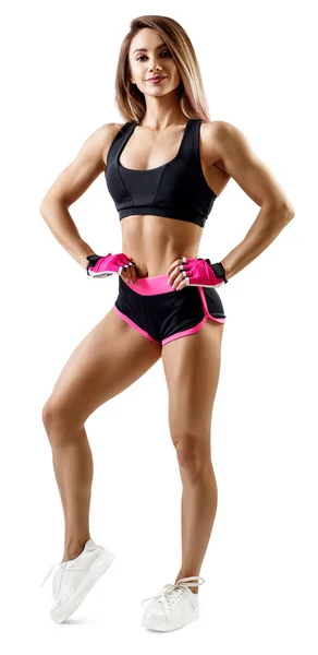 Kvinna i sportkläder visat sin muskulösa atletisk kropp. — Stockfoto