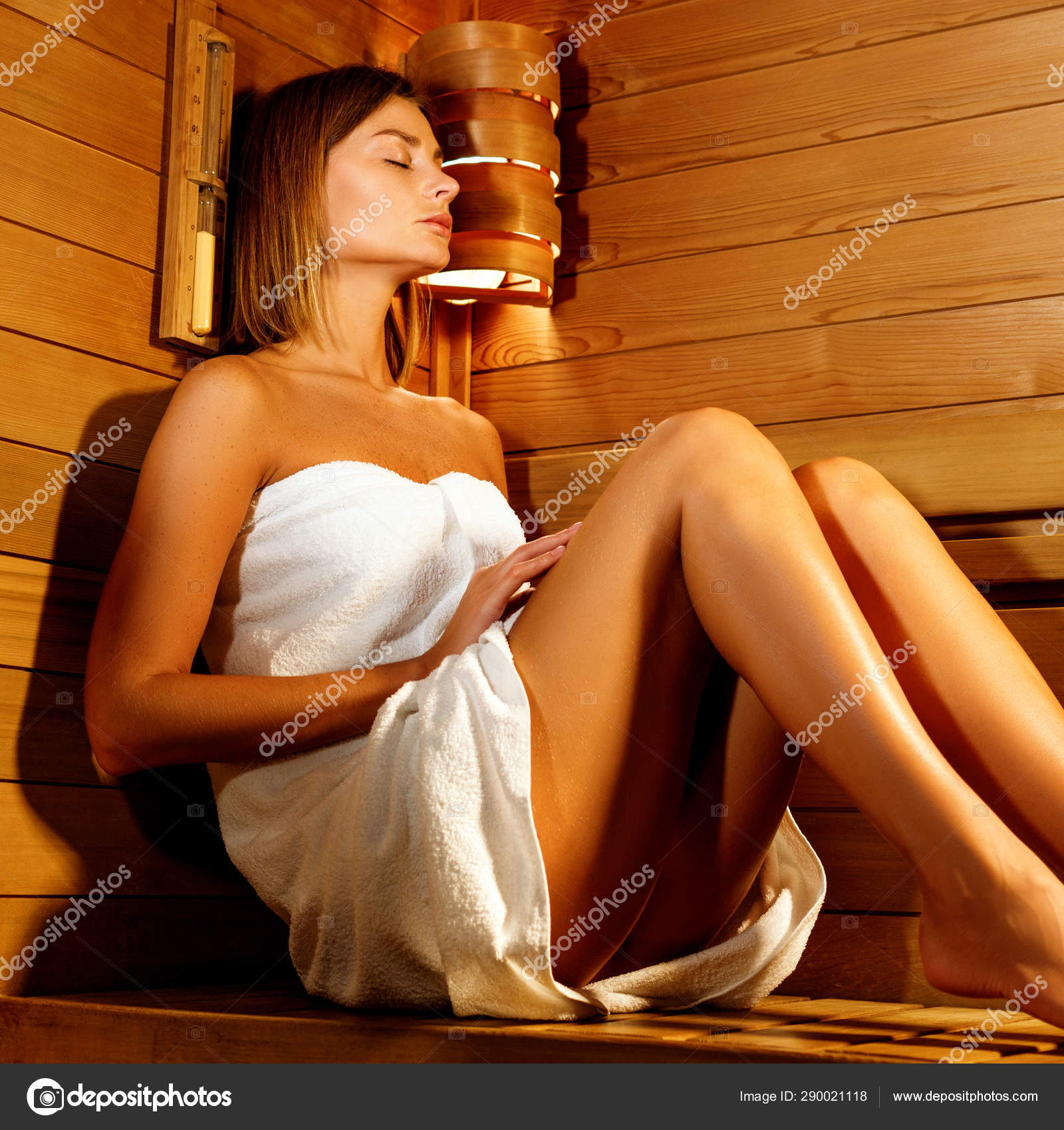 A Beautiful Woman Wearing A White Towel Takes A Sauna The Sauna Is