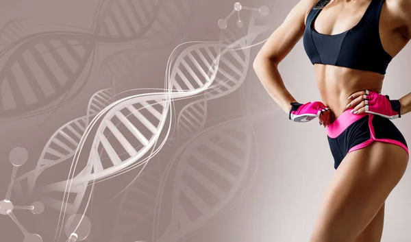 Athletic fitness woman standing among DNA chains. — Stock Photo, Image