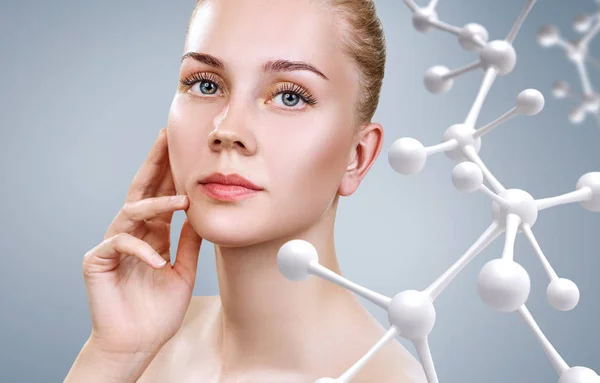 Beautiful young woman near big white molecule chain. — Stock Photo, Image