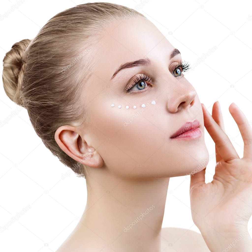 Sensual woman with cream dots on face.