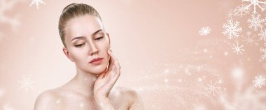 Kar taneleri ile bej arka plan üzerinde genç kadın.