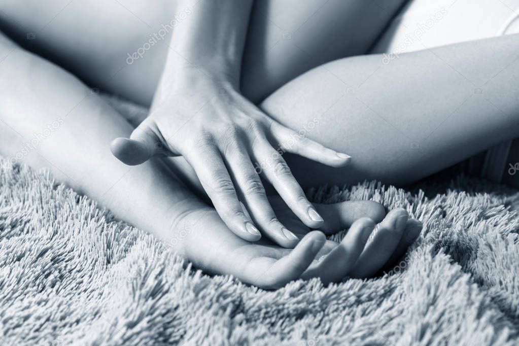 Sexy couple doing erotic massage in bedroom.