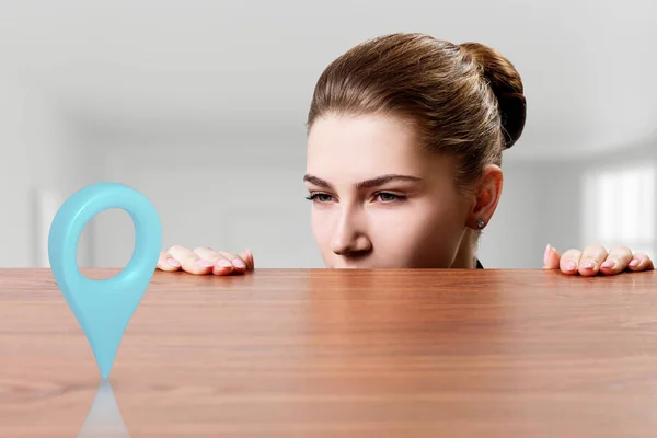 Business woman looking on gps pointer under the edge of table. — Stock Photo, Image