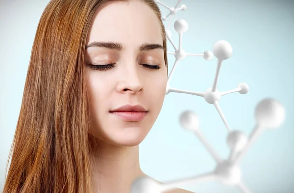 Young beautiful woman with big white molecule chain. — Stock Photo, Image