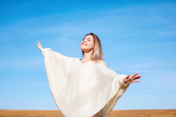 Cheerful girl with raised hands on the field in warm autumn season. — Stock Photo, Image