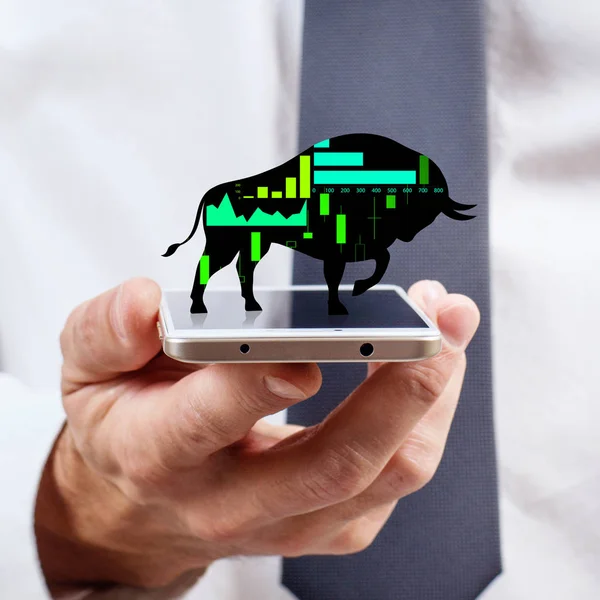 Silhouette of trading bull on the smatrphone screen.