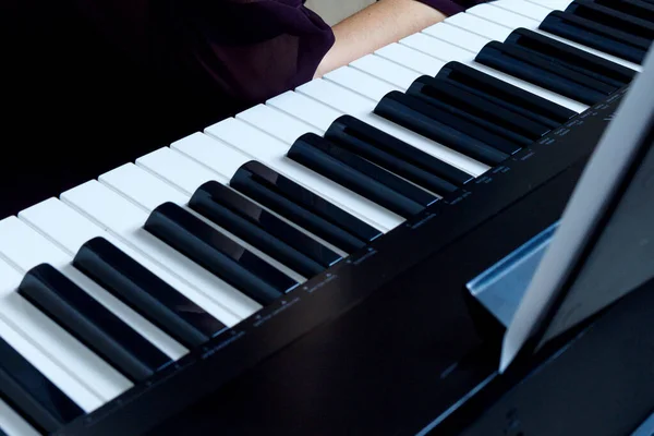 Close-up view on piano keyboard.