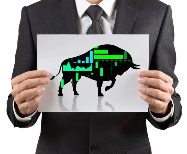 Homem de negócios detém papel com silhueta preta ícone financeiro touro . — Fotografia de Stock