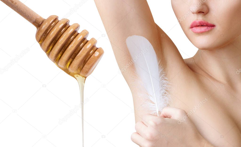 Woman holds feather near clean armpit and honey spoon.