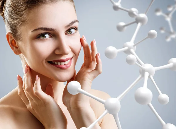 Young woman with big glass molecule chain. — Stock Photo, Image