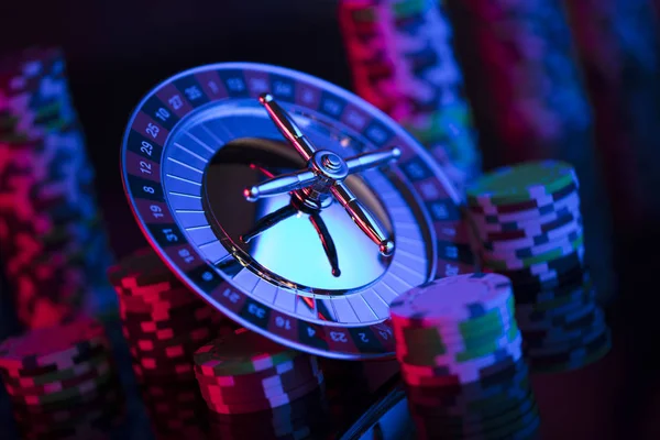 Casino. High contrast image of casino roulette. Poker chips. Bokeh background.