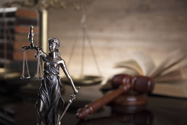 Law theme. Thems, gavel, scal and legal books on brown background.
