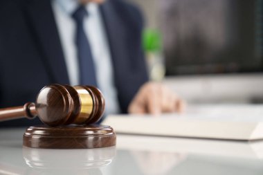 Avukat kavramı arka plan. Ofiste çalışan avukat. Tokmak ve beyaz cam masa üzerinde yasal kitap.