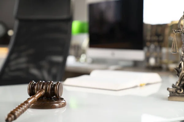 Lawyer concept background. Lawyer working at the office. Gavel and legal book on the white glass table.