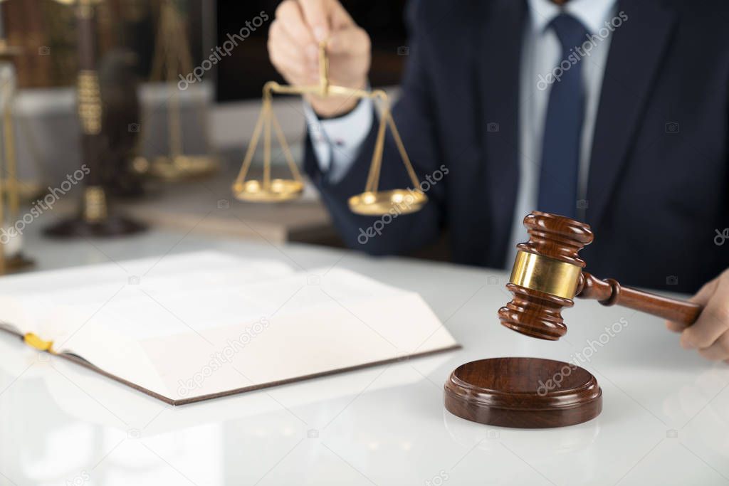 Lawyer concept background. Lawyer working at the office. Gavel and legal book on the white glass table.