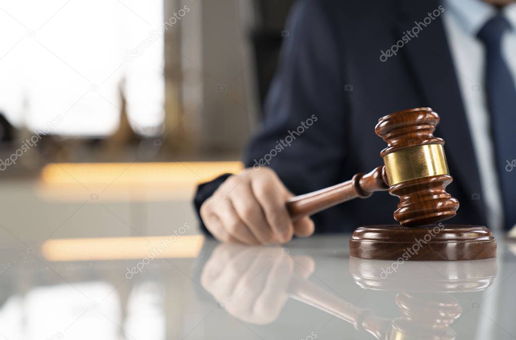 Lawyer concept background. Lawyer working at the office. Gavel and legal book on the white glass table.