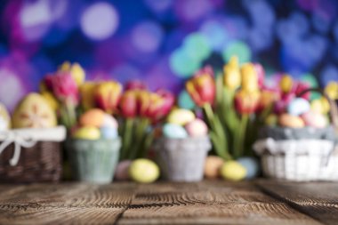 Paskalya arka plan. Paskalya süsleri. Rustik ahşap masa. Paskalya yumurtaları sepetle. Mavi bokeh arka plan.