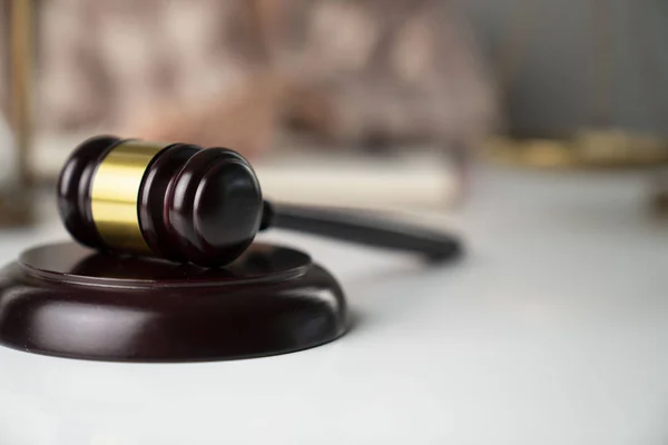 Female attorney in the legal office. Gavel and legal code on the white table.