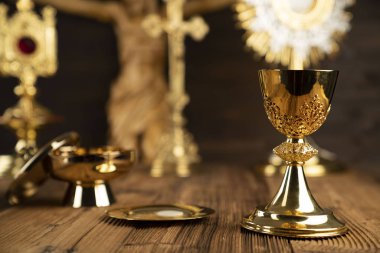 Catholic concept background. The Cross, monstrance, Jesus figure, Holy Bible and golden chalice on the altar. clipart