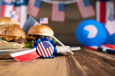 4 Temmuz kutlamaları. Amerikan bayrağı ve madalyaları. Köy ahşap masada hamburgerler.