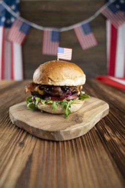 4 Temmuz kutlamaları. Amerikan bayrağı ve madalyaları. Köy ahşap masada hamburgerler.