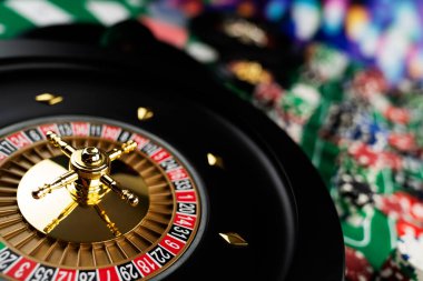 Kumarhane teması, ruleti kapat, kırmızı ve siyah numaralar. Arkaplanda çip yığını.