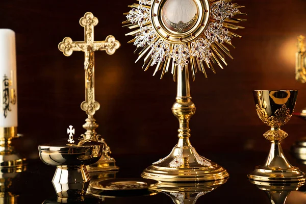 Catholic religion concept. Catholic symbols composition: The Cross, monstrance and golden chalice.