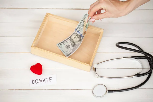 Donations and Charity. Donation Concept. Box of Donations and Heart on the White Background.