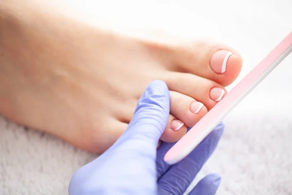 Closeup Photo of a Female Feet at Spa Salon on Pedicure Procedur.Care. Beautiful Women's Feet with Pedicure in Beauty Salon. Spa Manicure.