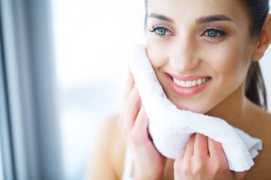Yüz yıkama. Mutlu kadın cilt havlu ile kurutma