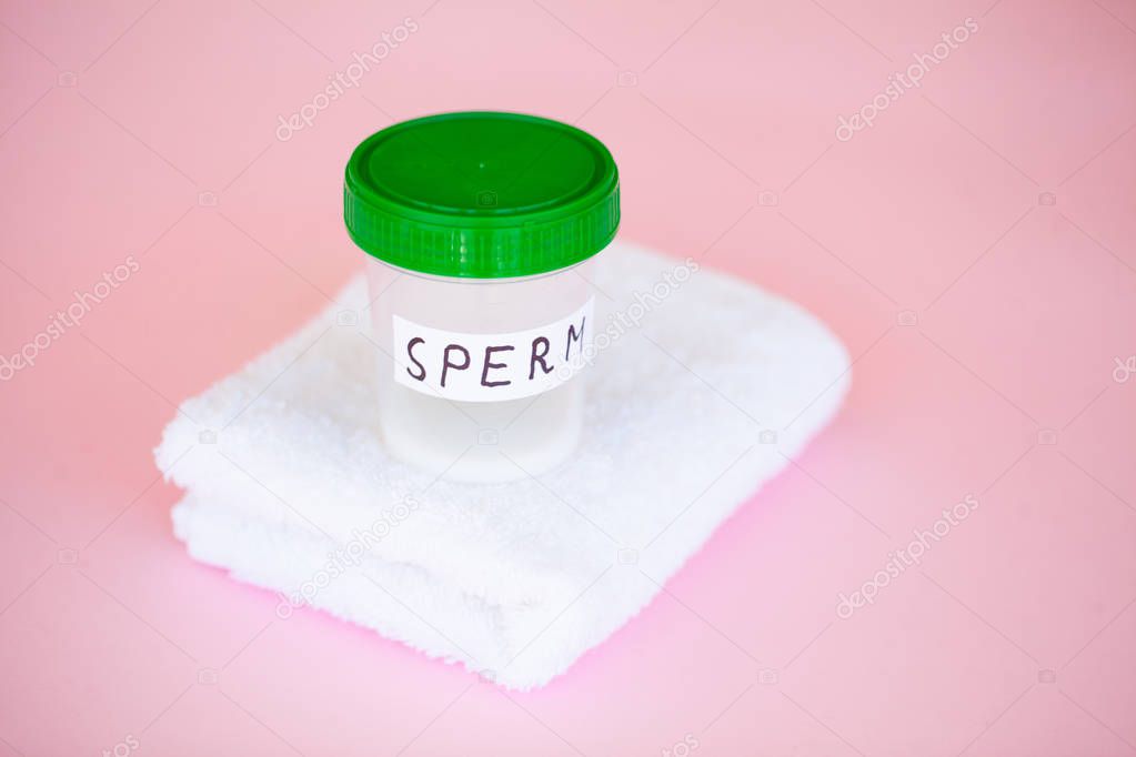 Health. Close up Sperm Analysis. Concept of Bank Sperm. Infertility Bank with Sperm on Pink Background with Towel.