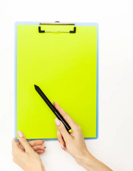 Blank Folder with Green Paper. Hand that Holding Folder and Pan Handle on White Background. Copyspace. Place for Text.