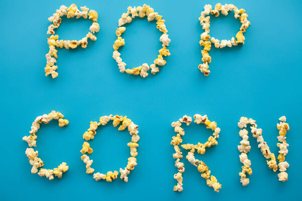Food. Frozen Popcorn Corn Popcorn bucket. Delicious Popcorn on Blue Background. Cinema.