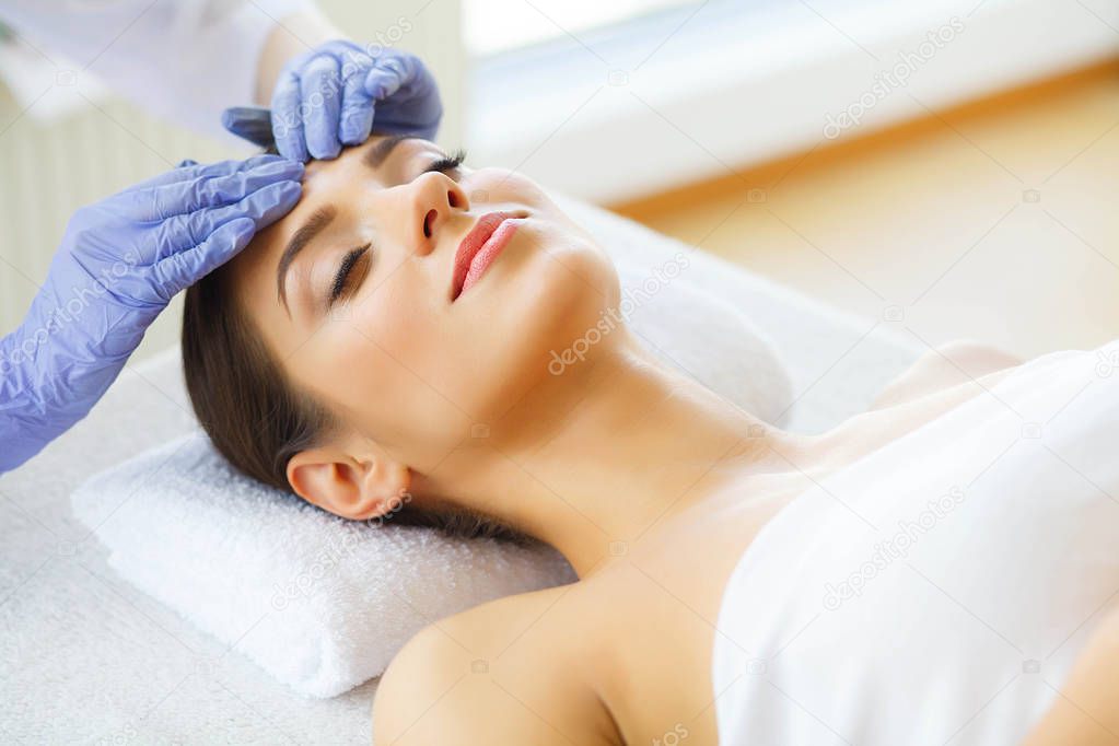 Skin Care Skin Procedures. Beautiful Young Woman in Spa Salon. Lying on Massage Tables and Relax. High Resolution