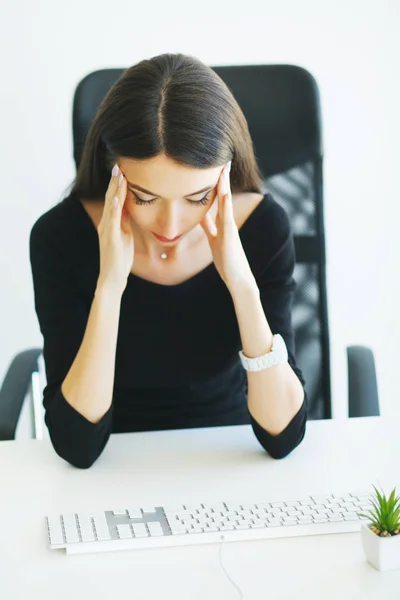 Pain. Business Woman suffering from a neck pain from bad posture in her an office.