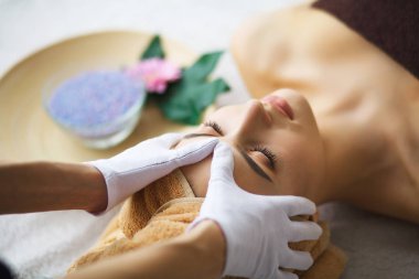 Masör yapıyor spa salonda bir kadın baş masajı