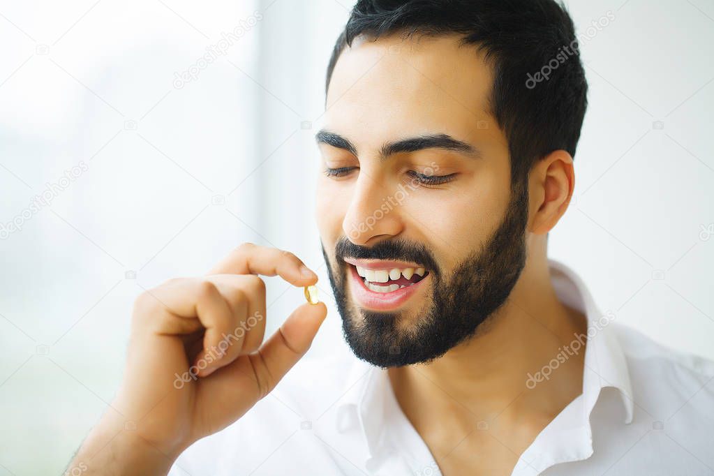 Beautiful Man Taking Pill, Medicine. Vitamins And Supplements