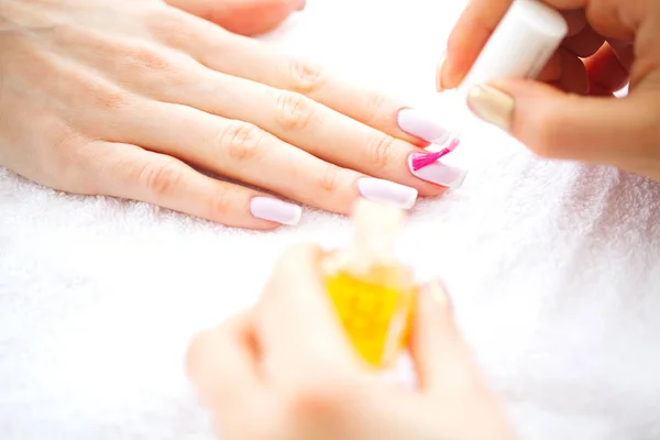 SPA manicure. French manicure at spa salon. Woman hands in a nail salon receiving a manicure procedure. Manicure procedure.