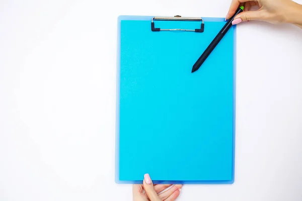 Blank Folder with Blue Paper. Hand that Holding Folder and Pen on White Background. Copyspace. Place for Text.