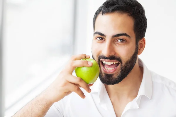 Man Eating Apple. Beautiful Girl With White Teeth Biting Apple. High Resolution Image.