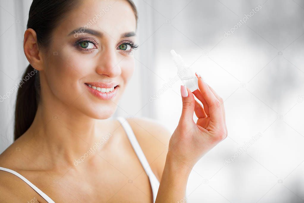 Health and Beauty. Eye Care. Beautiful Young Woman Holding Drops For Eyes. Good Vision. Happy Girl with Fresh Look.