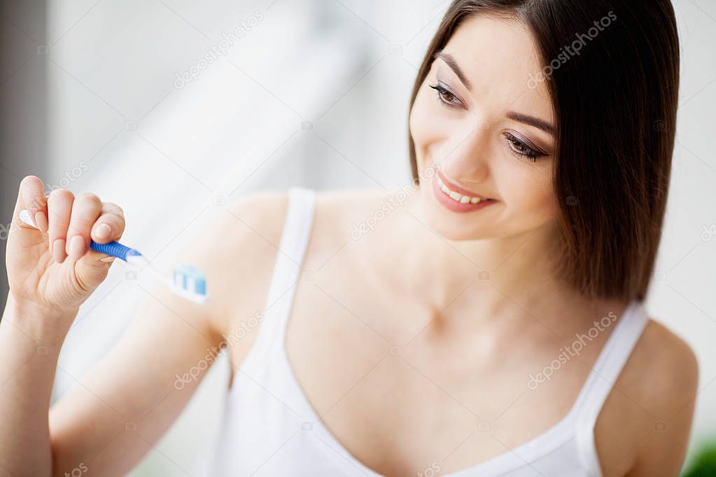 Beautiful Smiling Woman Brushing Healthy White Teeth With Brush. High Resolution Image.