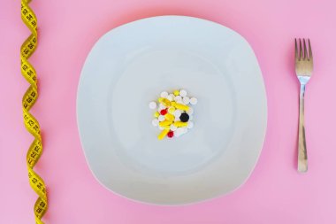 Tıbbi kavramı. Renkli hap ve kapsül çatal ile plaka üzerinde. Eczane tema, kapsül hap ilaç antibiyotik paketleri ile.