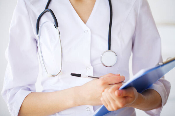 Doctor Woman With Stethoscope In Hospital. Concept Of The Global Healthcare And Medicine.