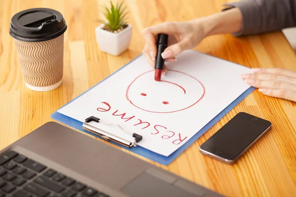 Blank of paper is on a wooden desk. Blank a4 paper is in the middle of wood office desk table with supplies. Top view with copy space, flat lay.