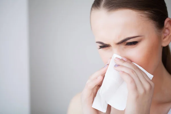 Woman Suffering From Cold In Home With Tissue
